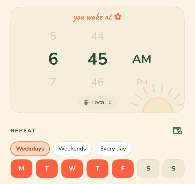 An alarm’s time picker headed “you wake at”, set to 6, 45 and AM, with 5, 7, 44, 46 and PM dimmed above and below in the wheels, and a control at the foot of the card reading “Local”. Under a “REPEAT” heading, the chip “Weekdays” is selected beside “Weekends” and “Every day”, and the day squares M, T, W, T and F are selected while both S squares are not.