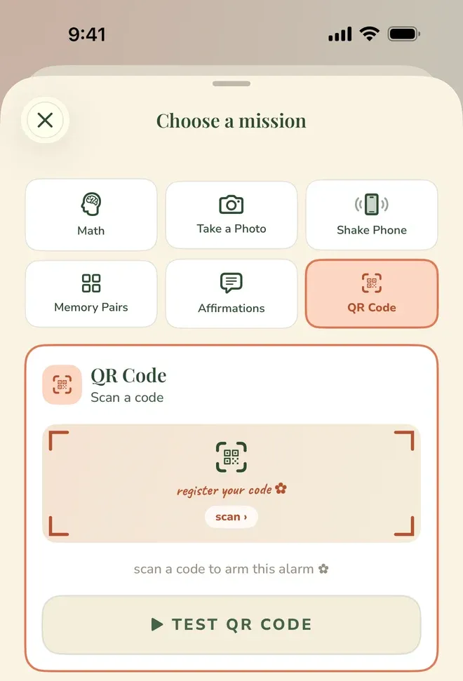 A “QR Code” mission card, subtitled “Scan a code”, open inside the mission chooser. A framed scan area reads “register your code” with a “scan ›” button, above the line “scan a code to arm this alarm” and a “TEST QR CODE” button.